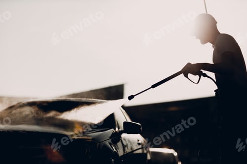 Preview: Worker washing car at self-service car wash