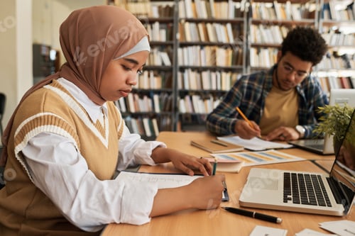 Preview: Muslim girl writing exam in class