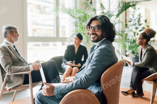 Preview: Confident professional in a meeting with colleagues in a bright office space.
