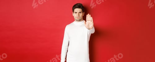 Preview: Image of serious and confident man telling to stop, forbid something, extending one hand and