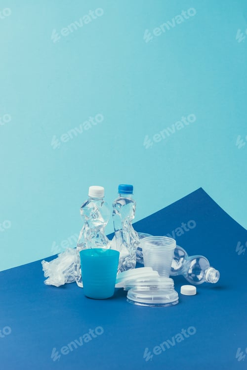 Preview: close up view of various plastic trash on blue background, recycle concept