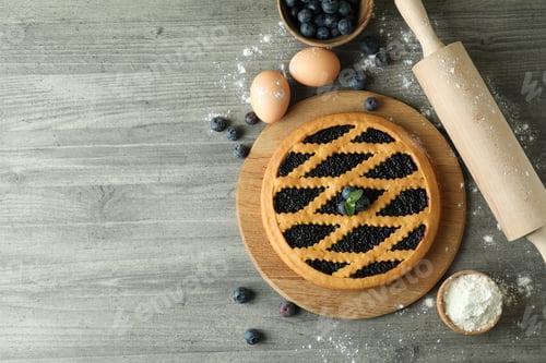 Preview: Concept of cooking blueberry pie on gray textured background