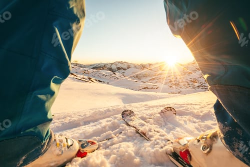 Preview: Skier athlete man standing in front of wonderful sunset in ski resort