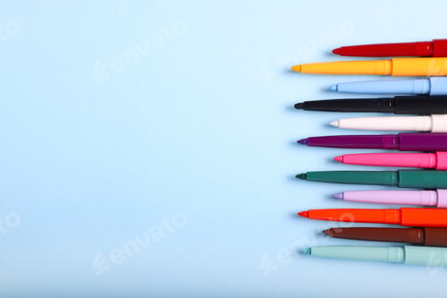 Preview: Colorful twist up eye pencils on light blue background, flat lay. Space for text