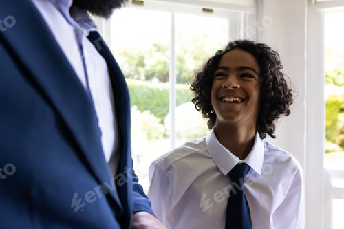 Preview: Young boy in formal attire smiling joyfully during bar mitzvah indoors