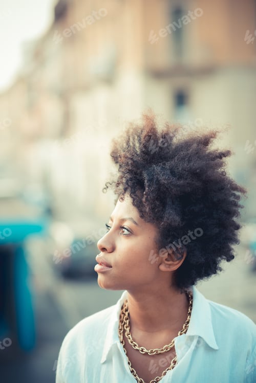 Preview: Portrait of beautiful young woman gazing in city