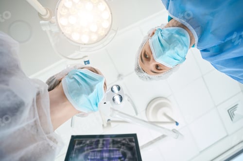 Preview: Surgeon dentist with an assistant are in the operating room