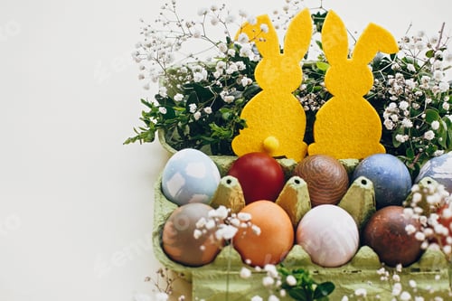 Preview: Natural dyed easter eggs and rabbit decorations on wooden background