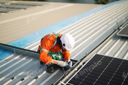 Preview: Workers Installing Solar Panels on warehouse Roof.