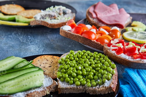Preview: Assorted open-faced sandwiches, sandwiches with slices of sourdough with various fillings on a platе