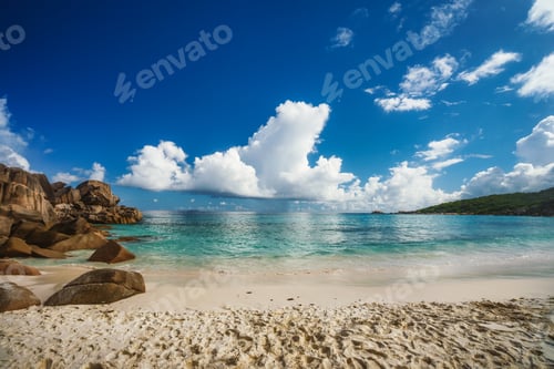 Preview: Grand Anse beach at La Digue island in Seychelles. Sandy beach with blue ocean and white clouds on