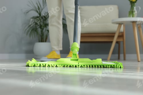 Preview: Woman cleaning floor with microfiber mop indoors, closeup