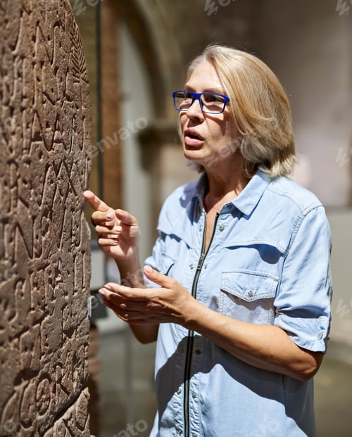 Preview: Woman Studying Ancient Writing Hieroglyphs At Museum