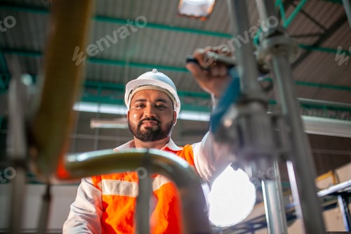 Preview: professional technician engineer with safety hard hat working in industrial factory.