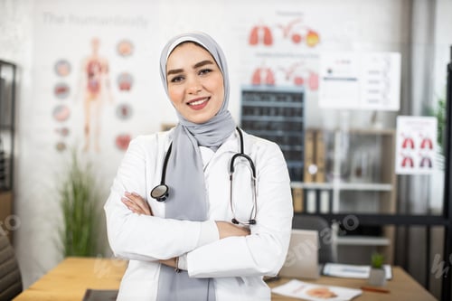 Preview: Muslim female doctor with stethoscope on neck posing indoors