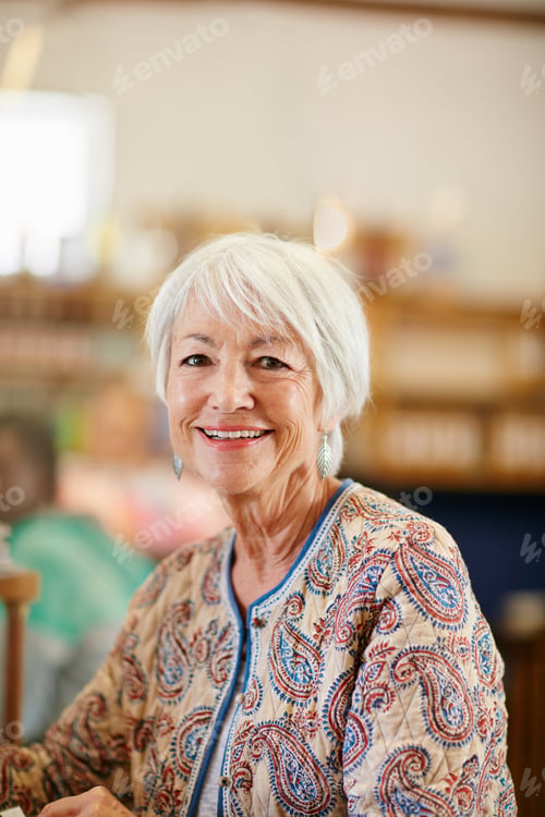 Preview: She lives life with a smile. Portrait of a smiling senior woman in a cafe.