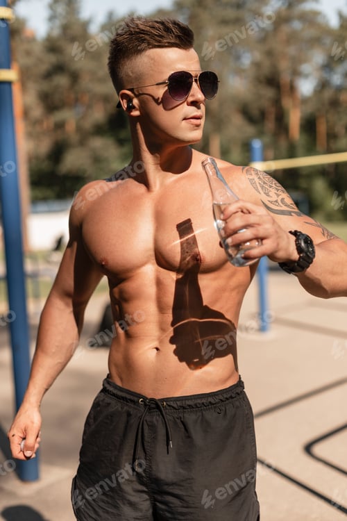 Preview: Cool handsome healthy muscular athletic man training outdoors