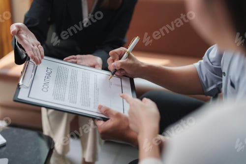 Preview: Businesswoman signing contract after successful negotiation with partners