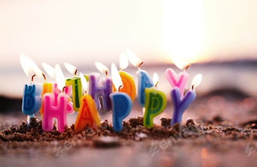 Preview: Birthday candles burning on a seashore