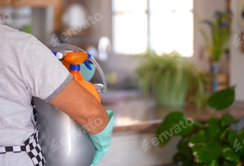 Preview: Senior retired woman busy with house hygiene works holding a bucket full of cleaning products