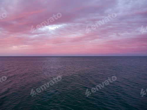 Preview: Sunset sky over sea in the evening with colorful clouds orange