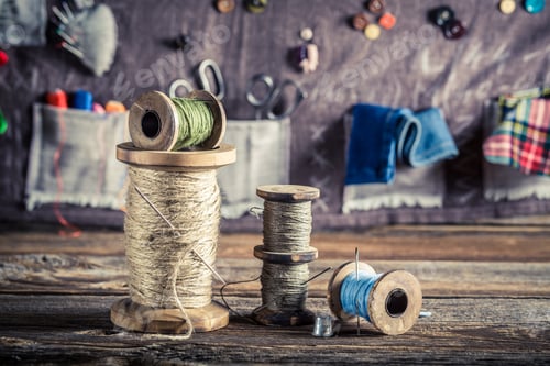 Preview: Sewing mat made of buttons, needles and threads in tailor workshop