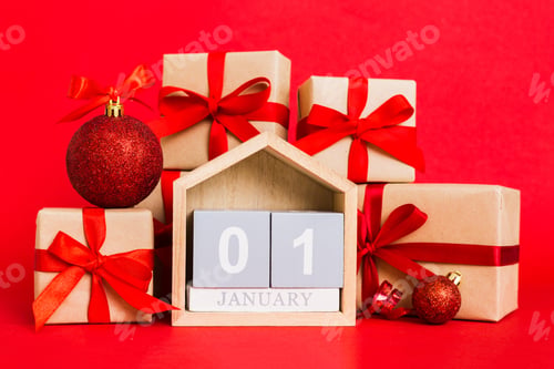 Preview: 1 january. Christmas composition on colored background with a wooden calendar