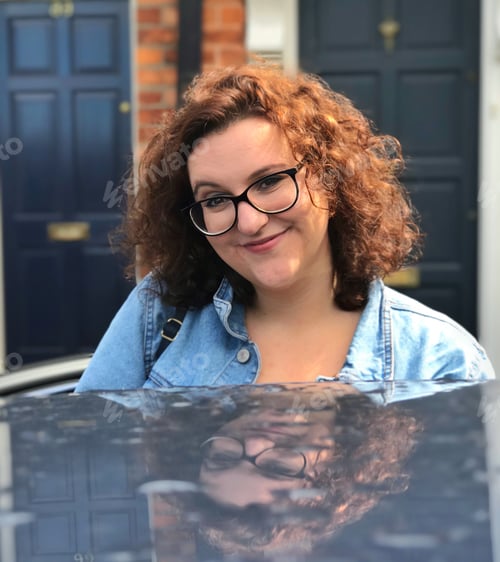 Preview: Millennial young woman and auto rooftop reflection smile with doors in background