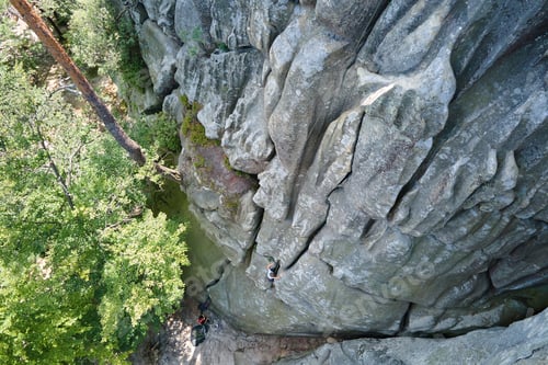Preview: Aerial view of large rocky formations with snone boulders and mountain high cliffs