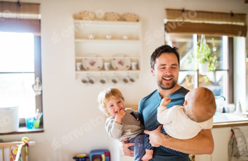 Preview: Father with two toddlers at home.