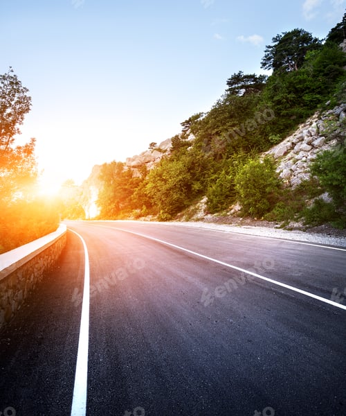 Preview: Asphalt road in summer forest at sunset. Crimean mountains