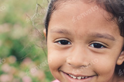 Preview: A beautiful little girl with dark brown hair and eyes smiling