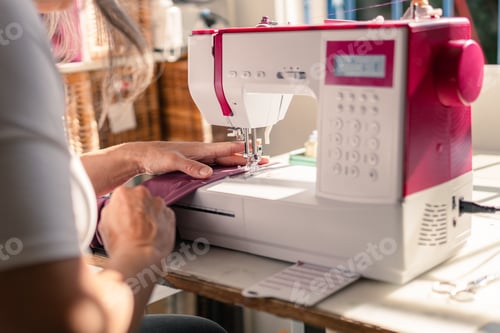 Preview: Woman Sews Fabric with Pink and White Machine
