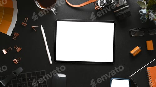Preview: Top view of digital tablet, camera, coffee cup and photographer accessories on black leather.