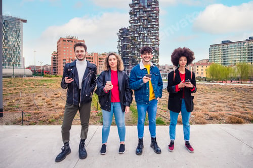 Preview: Group of multiethnic friends millennials using mobile phones