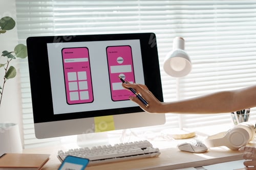 Preview: Designer working on user interface creating mobile application prototype