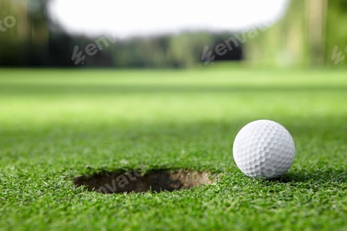 Golf Ball Near the Hole on a Green Course