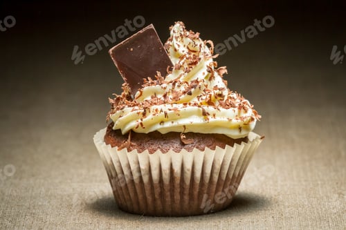 Preview: Closeup brown muffin with chocolate chip and vanilla cream