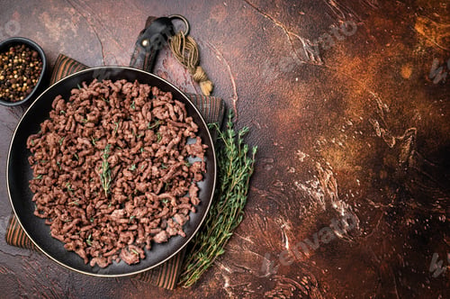 Preview: Fried mincemeat, cooked forcemeat in a plate. brown background. top view