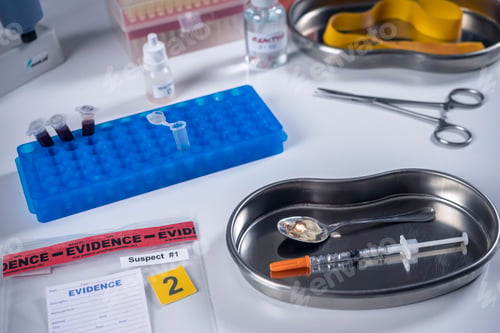 Preview: Syringe and spoon in police drug investigation department, concept image