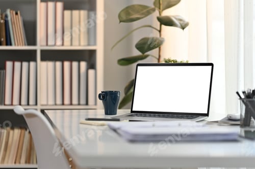 Preview: White working desk in modern home office with laptop computer, coffee cup and documents.