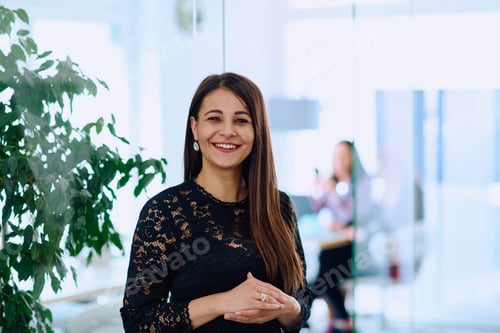 Preview: Portrait of a Confident Businesswoman with Crossed Arms in Her Office Environment.