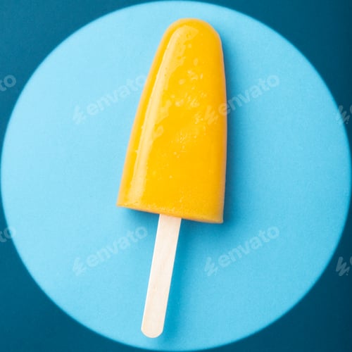 Preview: Single homemade orange popsicle on a blue background. Top view