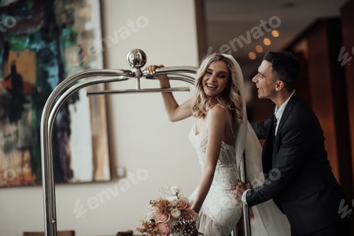 Preview: Happy authentic candid couple in love indoor at luxury hotel date in wedding apparel