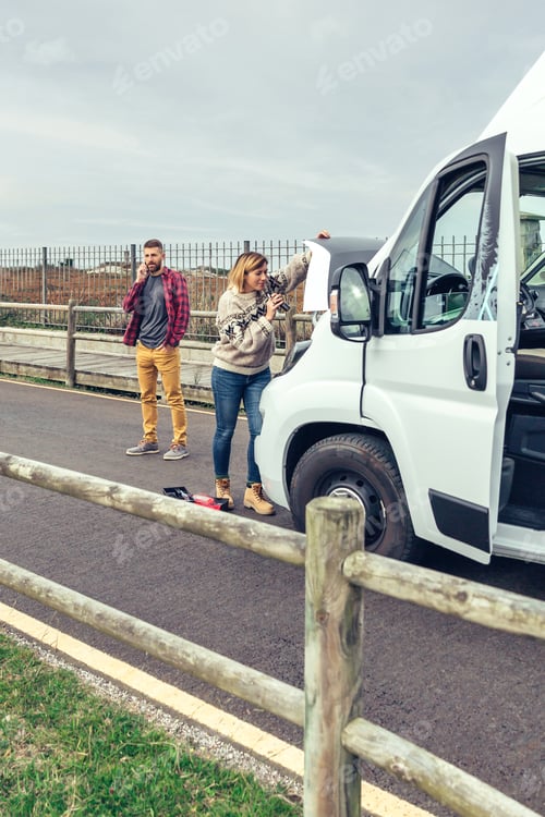 Preview: Woman repairing broken down campervan