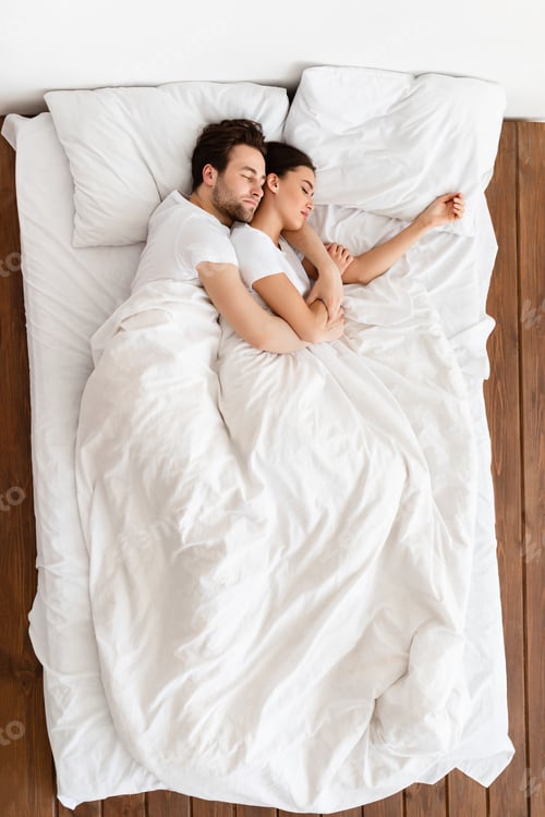 Preview: Top-View Of Married Couple Sleeping Together Embracing Resting In Bedroom