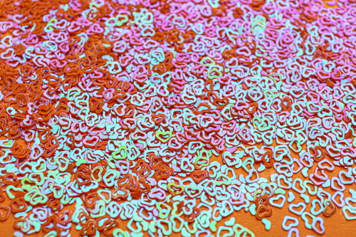 Preview: Shiny bright heart shaped glitter as background, closeup