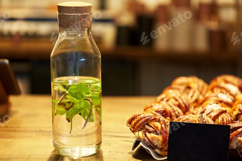Preview: fruit water in bottle and buns at grocery store