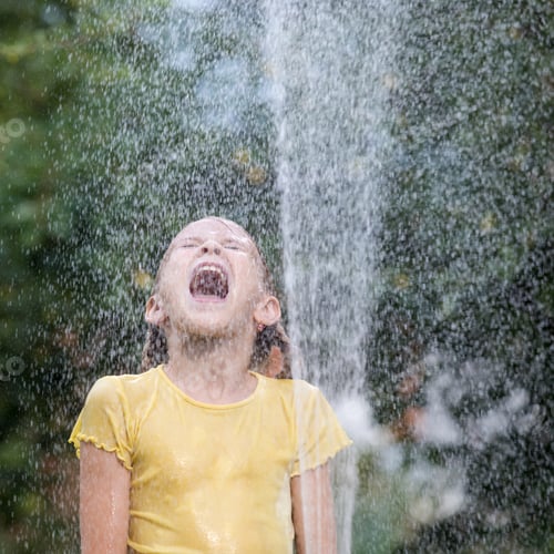 Preview: Girl Excitedly Plays in Water Outdoors on Summer Day