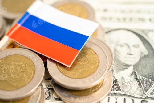 Preview: Stack of coins with Russia flag and US dollar banknotes.